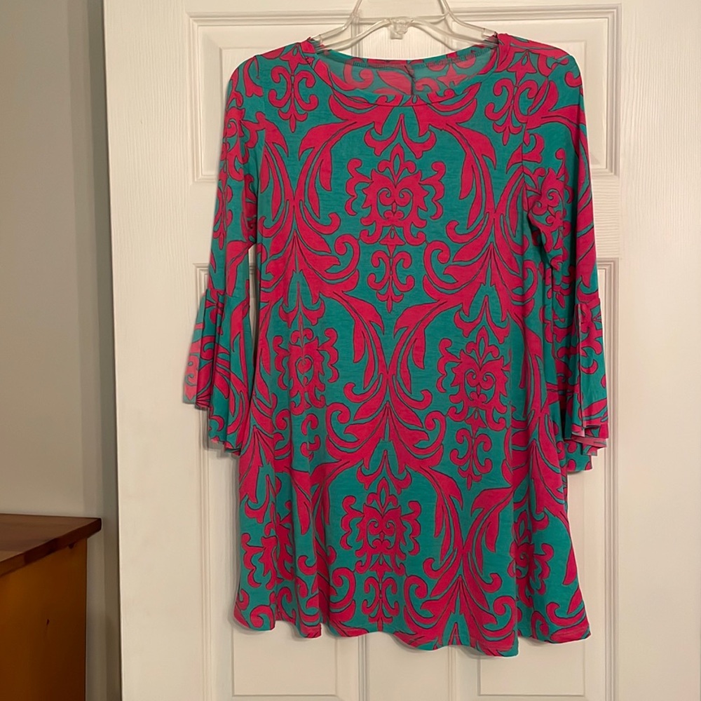 Pink and green patterned top with bell sleeves and pockets
